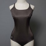 Speedo black nylon, used as a doubling suit for training, 1988– 1992. We’d wear two, sometimes three suits to train in, the extra layers and weight providing drag. The suits were made of nylon, more durable and less flexible than Lycra. Some men’s suits were built with mesh pockets that caught the water and billowed out in small cups at the hips. Before practice, we would keep our drag suits resting down around our hips. At a meet we’d roll them down wet after warm-up, as ballerinas roll legwarmers up over their knees and then down around their ankles. A black nylon suit would fade to a grayish- brown over time; a blue nylon suit to pinkish- gray.