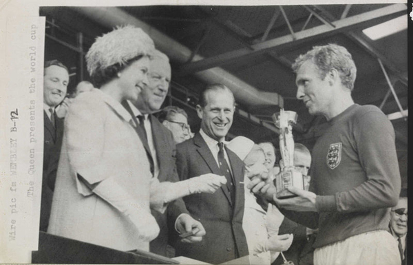 The_Queen_presents_the_1966_World_Cup_to_England_Captain,_Bobby_Moore._(7936243534)