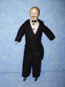 Man doll in typically ill-fitting suit.