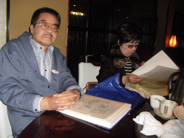 Tatsumi and his wife, Eiko, in Tokyo, 2012, at the a restaurant with Chris Oliveros. The stack of pages in front of Tatsumi are from a potential second volume of A Drifting Life.