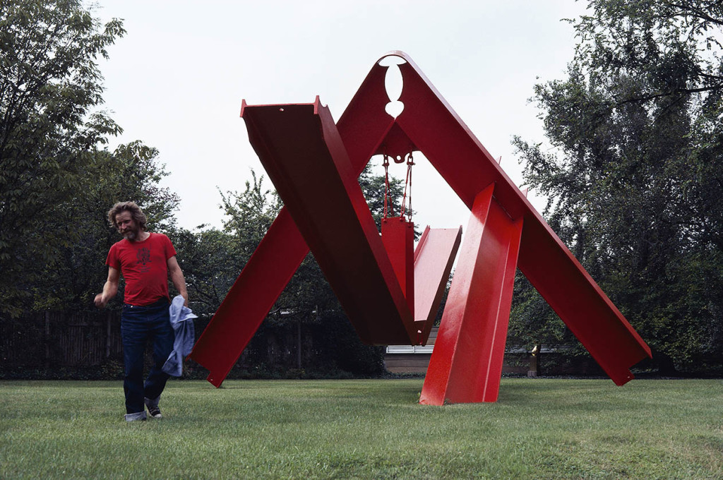 Mark di Suvero, photographed in St. Louis, Missouri, 1981, with his sculpture For Rilke, 1975-76, steel, 18 x 40 x 20', Private Collection, St. Louis, Missouri. Photo: ©George Bellamy